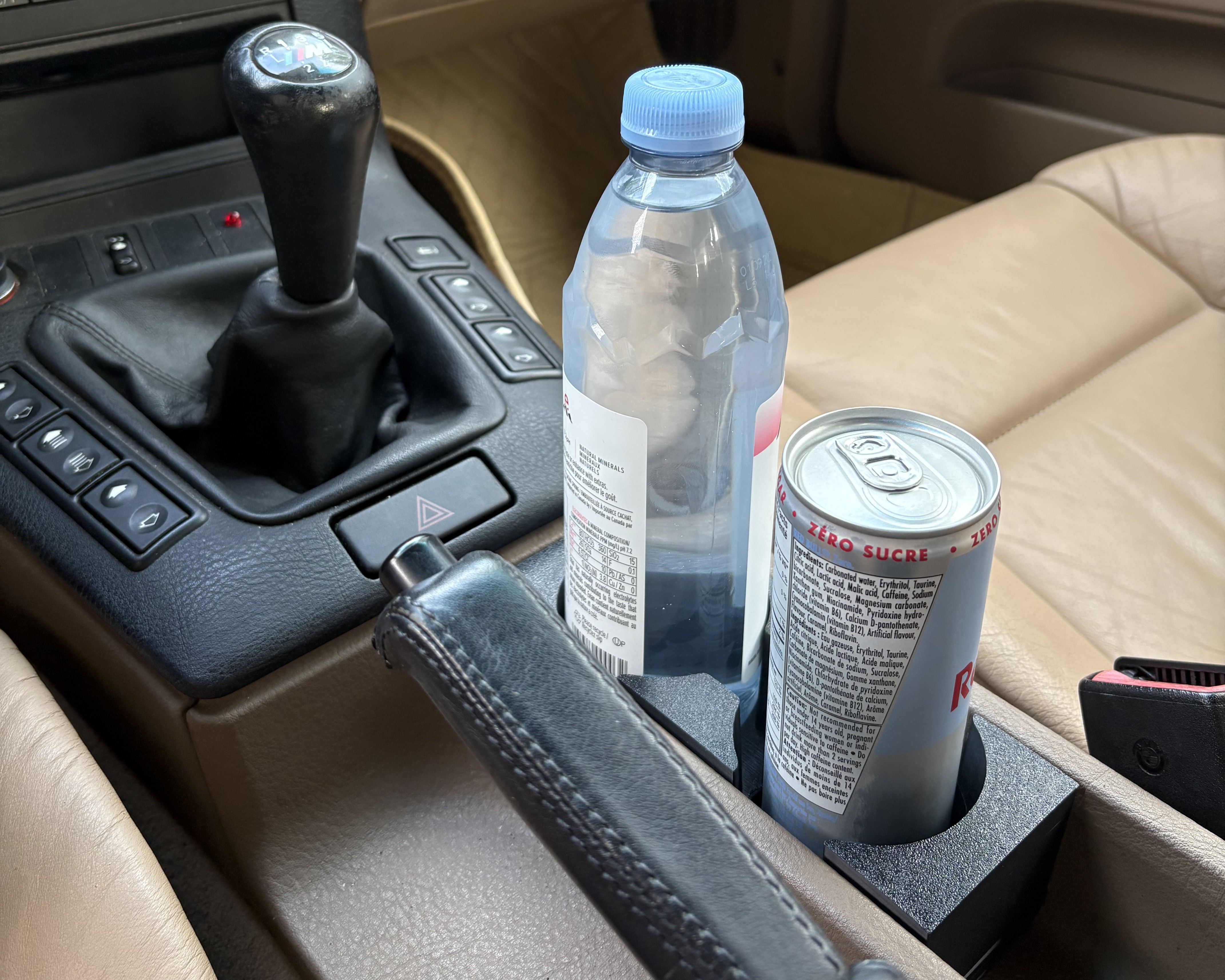 Finished cupholder installed in the E36 console holding drinks