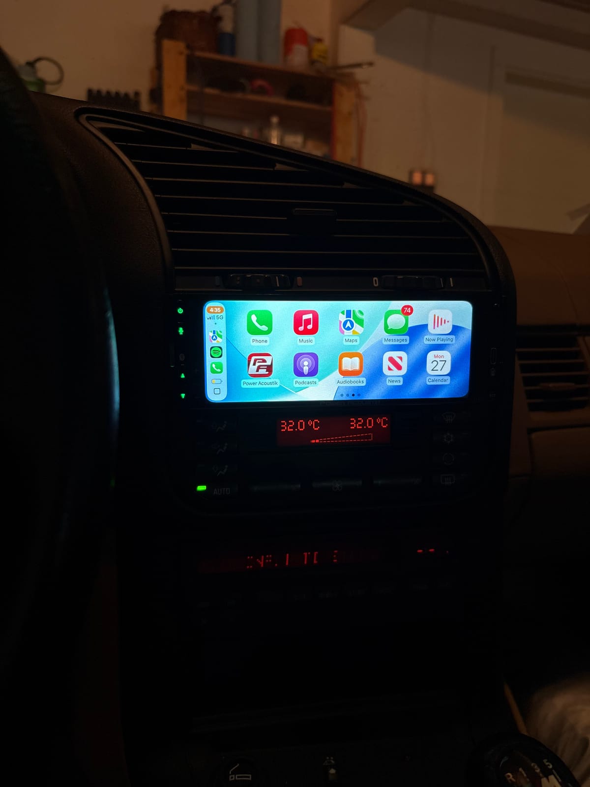 CarPlay screen installed in the dash, integrated with the factory climate controls